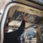 Technician installing sound deadening to the roof lining inside the Jimny.