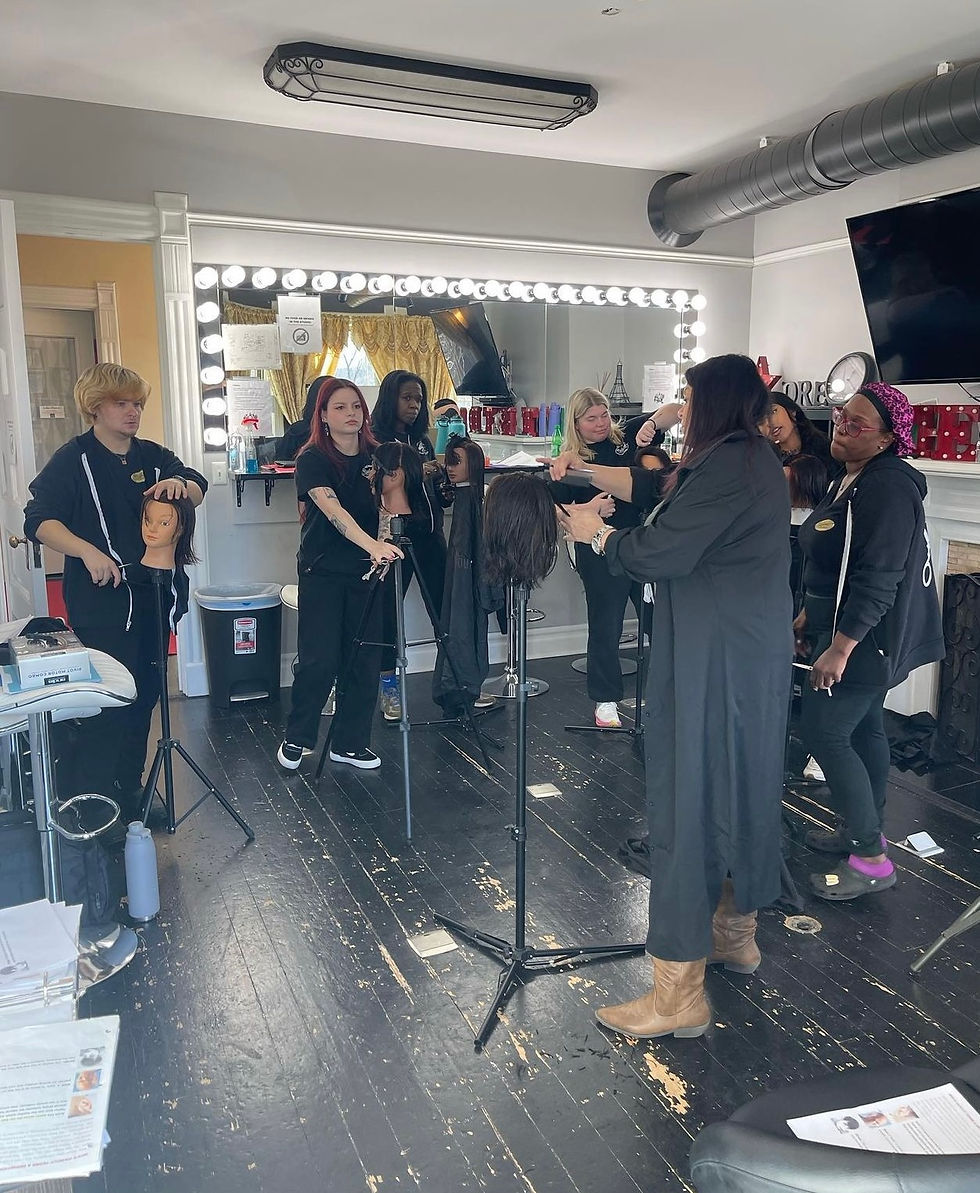 Eye-level view of a cosmetology classroom with students practicing hair styling