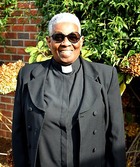 Picture of the Church Clerk a female  smiling with sunglasses on