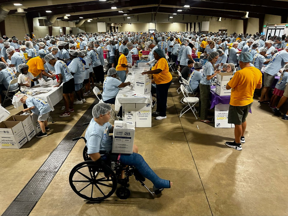Light Orlando Volunteers work to assemble one million meals at U Hunger Event