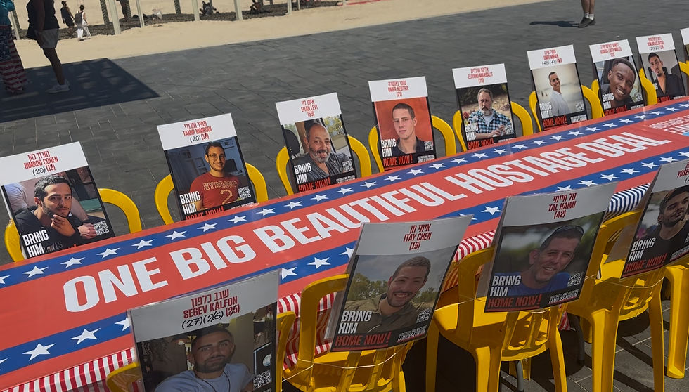 A Shabbat table situated outside the U.S. Embassy Branch Office in Tel Aviv with photos of the estimated 50 hostages in Gaza seated around it. "One Big Beautiful Hostage Deal" is written on the tablecloth. The display set up less than 24 hours after the passage of the "One Big Beautiful Bill" (Robert Sherman, NewsNation).