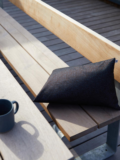 FÚ Tri cushion briga brown lying on wooden bench , metallic yarn, coffee mug. Fu Kissen