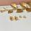 Thumbnail: Tiny Gold Iris February Birth Flower Stud Earrings With CZ