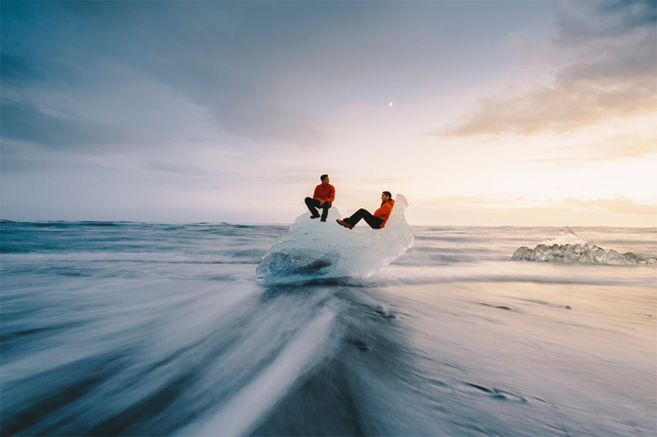 two people on a big chunk of ice