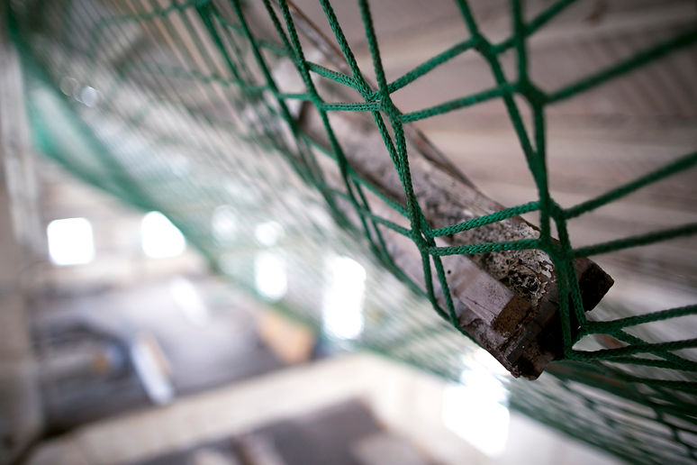 Using blue fall hights safety protection netting to catching a debris on construction buil