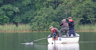Anglers Pike Fishing at Esthwaite Water on a boat.