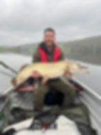 Pike fishing, boat on Esthwaite Water in the Lake District during the winter pike fishing season