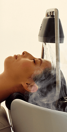 Guest relaxing during a head spa treatment with water and steam