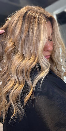 Long, wavy blonde hair with dimensional highlights