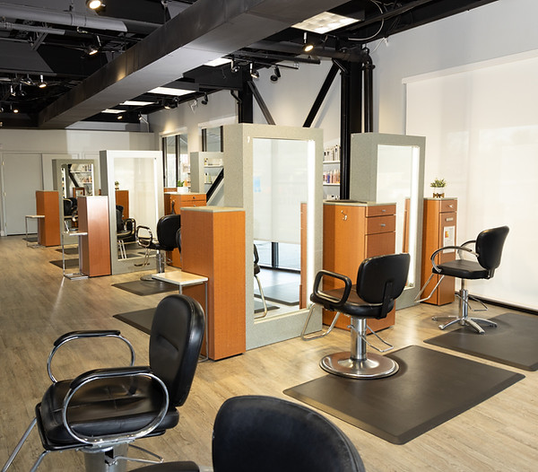 Salon Evolve styling area with individual mirrors, salon chairs and wood cabinetry