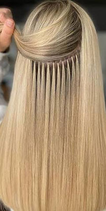 Rows of blonde hair extensions with the upper hair section lifted