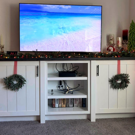 White custom entertainment center with built-in storage and shelving