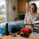 Organized hurricane preparedness supplies including water, flashlight and medications on a kitchen counter