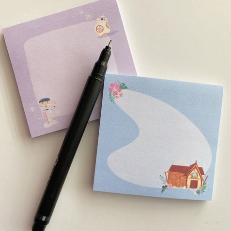 A little purple sticky notepad and a blue sticky notepad