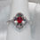 Thumbnail: Oval Ruby Halo Ring in 14K White Gold with Round Diamonds