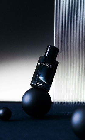 Dior Sauvage featuring fluted glass refraction and geometric prop styling, highlighting the premium texture and bold, cool aesthetic.