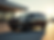 A sophisticated black luxury sedan, a GMC Yukon, parked elegantly in front of a modern air