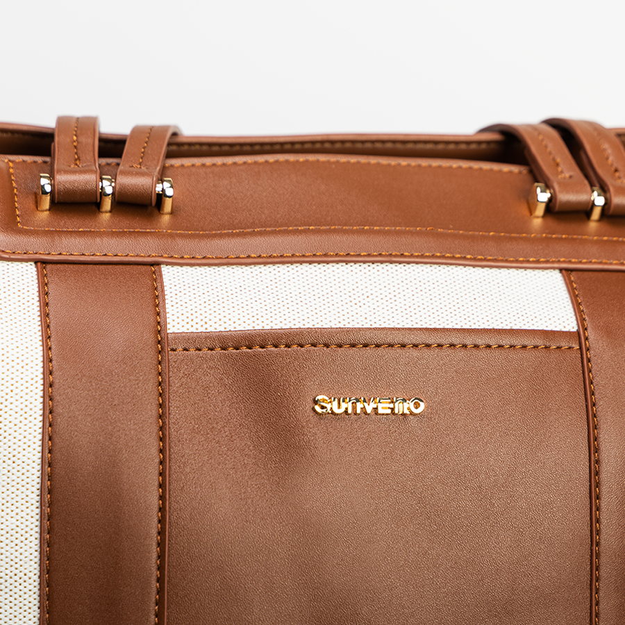 Close-up of the Sunveno logo on a canvas tote diaper bag.