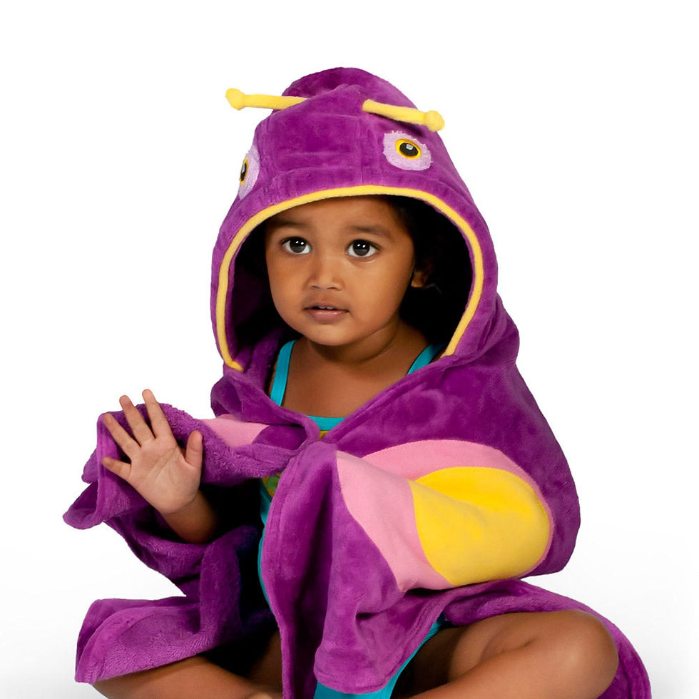 Child wearing a purple hooded butterfly towel with antennas.