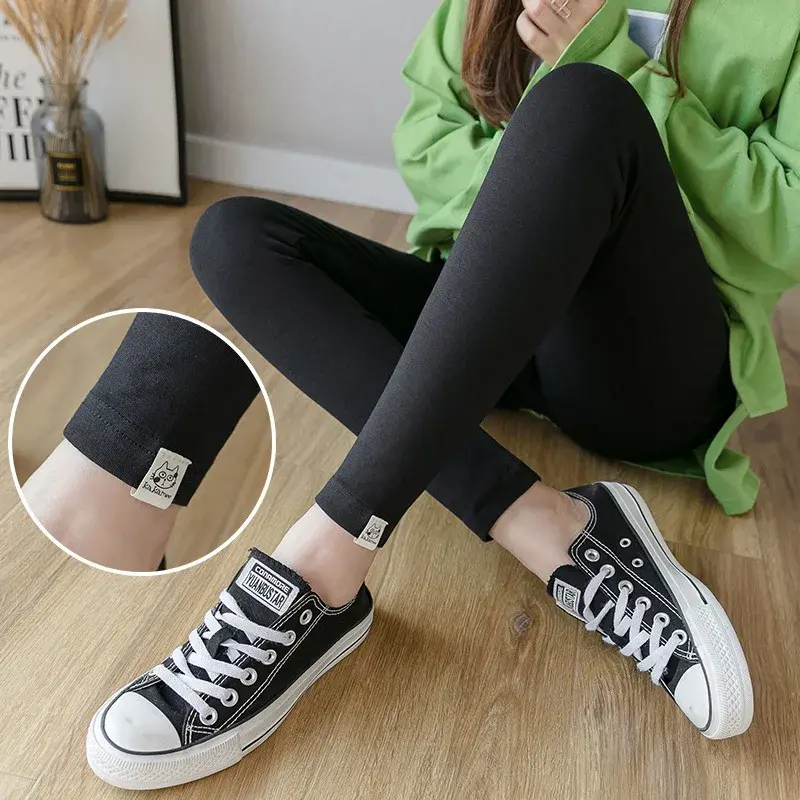Thumbnail: Woman wearing black leggings and sneakers sitting on a floor.
