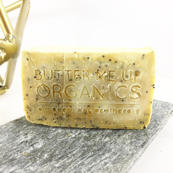 Butter Me Up Organics Lemon Poppyseed soap bar on stone.