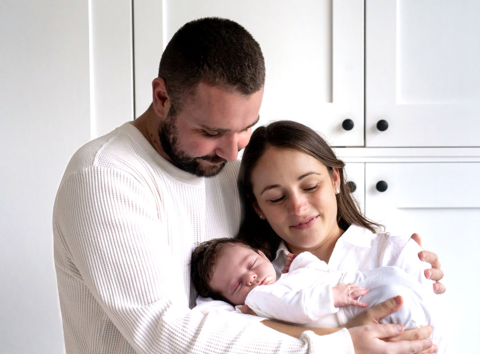 Newborn photographer Wigan – baby sleeping in parents arms