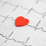 Electrocardiogram (ECG) graph paper with red heart, heart wave, heart attack, cardiogram r