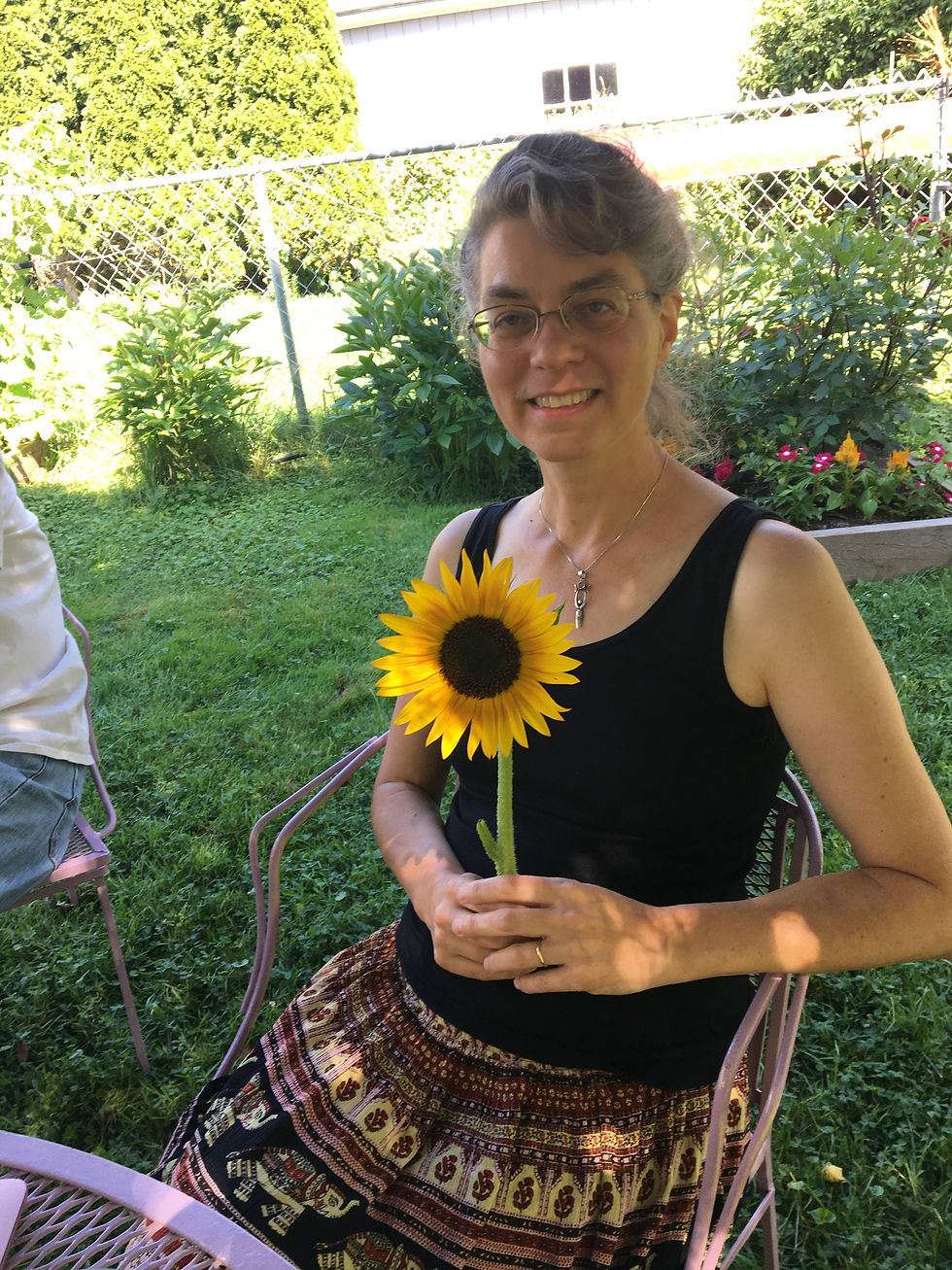 Dawn holding a sunflower at Flower Communion