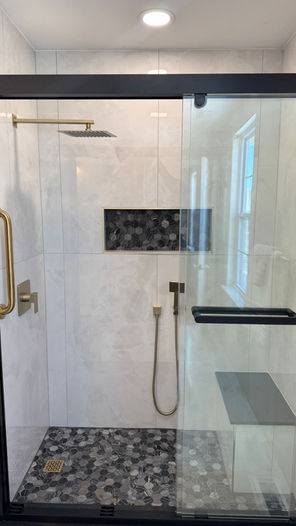 Large-format porcelain tile, walk-in shower with matte black finishes