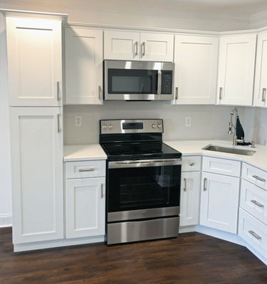Small white shaker kitchen cabinets.