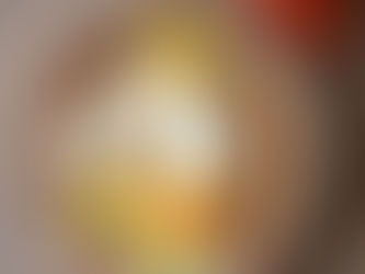 Fillable foods - Bowl of mixed beans, yogurt, nuts, and avocado slices with boiled eggs on wooden table; three tomatoes beside it. Bright and fresh.