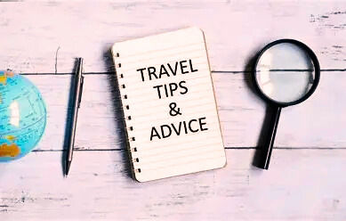 Travel tips and advice notepad, globe, pen, magnifying glass