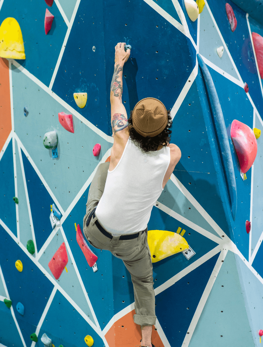 Male climber climbing with straight arms