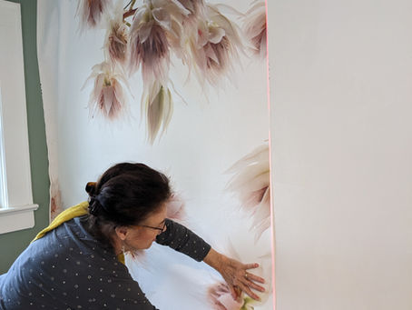 Installing a panel of floral wallpaper using a digital level