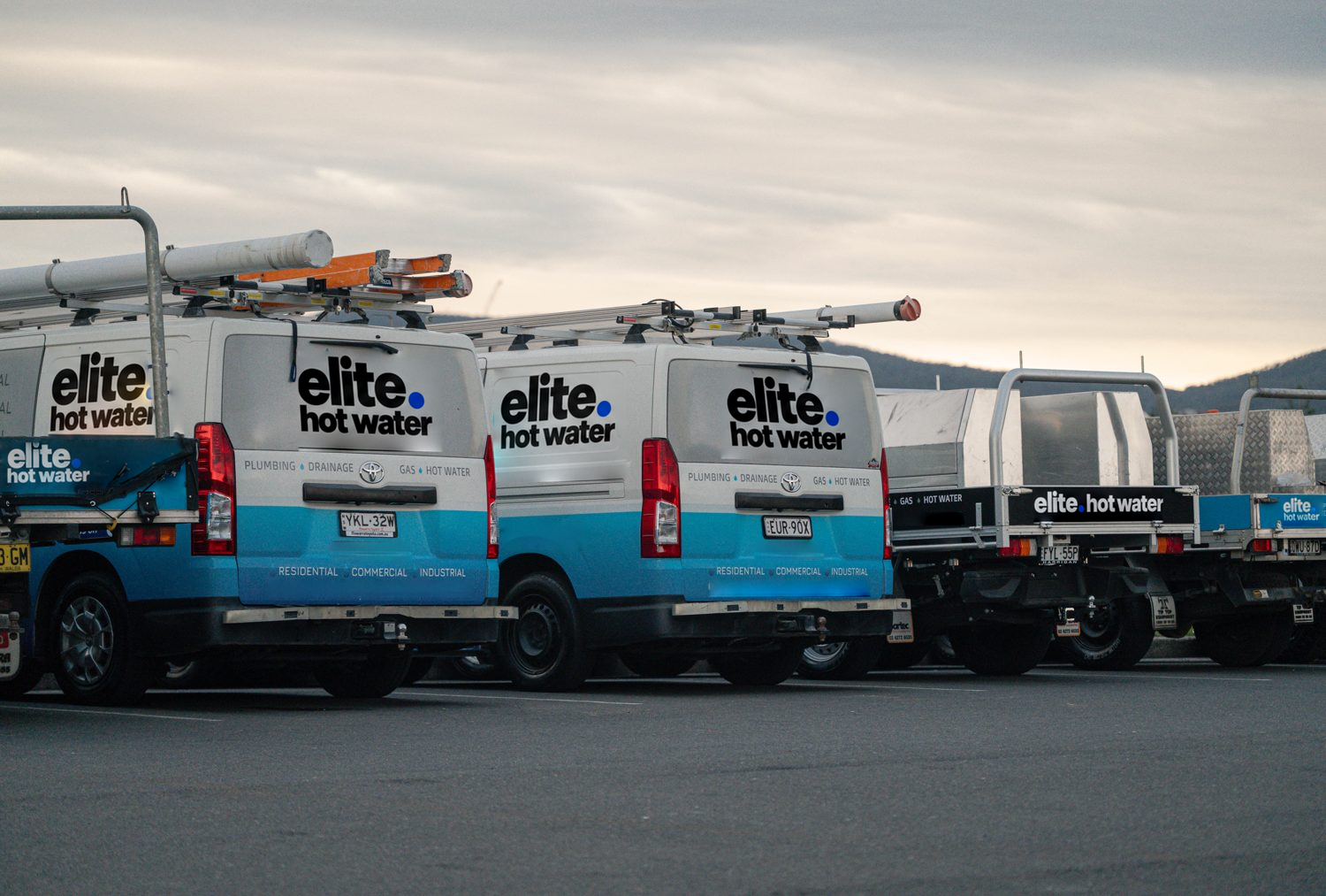 Elite Hot Water vehicles parked together
