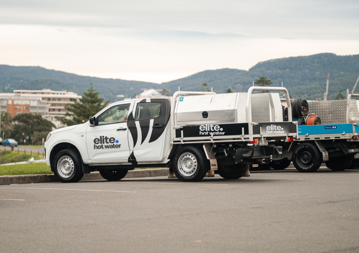 Elite Hot Water service vehicles parked together