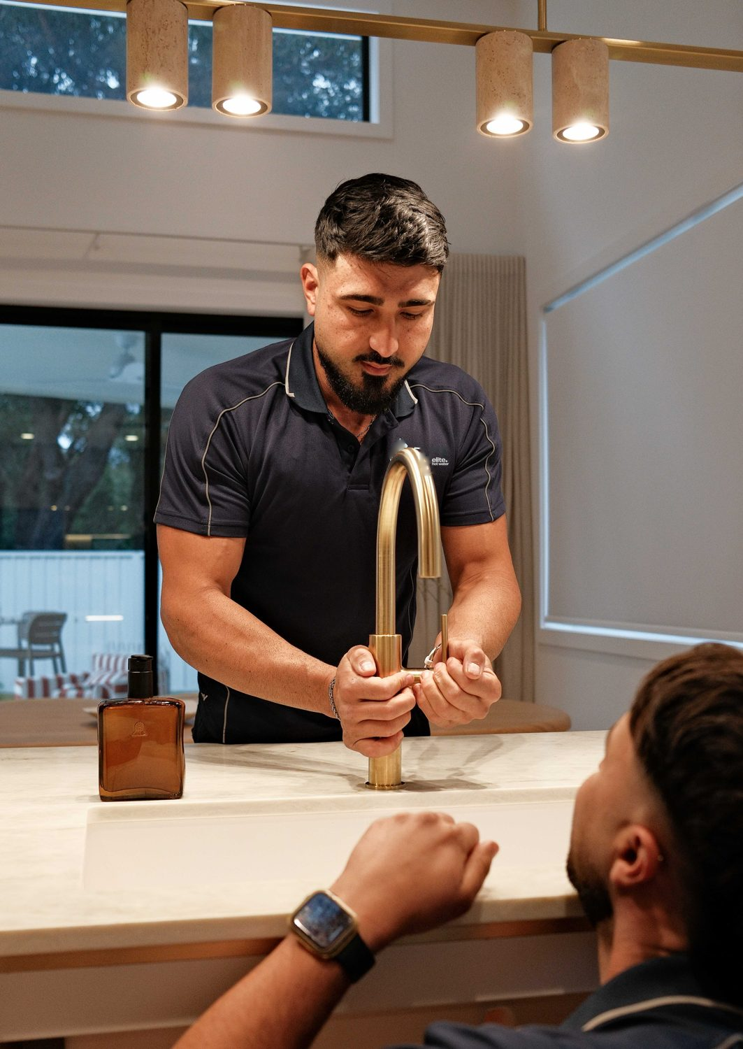 Elite plumber working on a kitchen tap