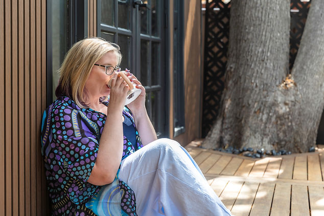 Wendy Bennett at her healing studio, sat down, drinking