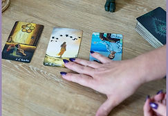 An example tarot spread showing 3 tarot cards on a wooden table