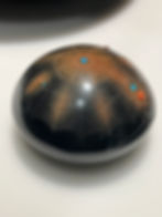 Barbara Gonzales Pohwhogeh Owingeh/San Ildefonso Pueblo, b. 1947. Black and sienna incised pottery with turquoise and coral inlay, 19705-80s. 3¼ by 5½ inches. Maria Martinez's great-granddaughter, Barbara Gonzales, has continued the family tradition while adding designs of her own inspiration. Heard Museum Collection, gift of Don and Jean Harrold, 4146-54. I took this picture on July 21, 2024, at "https://www.antiquesandthearts.com/maria-modernism-the-heard-museum/"