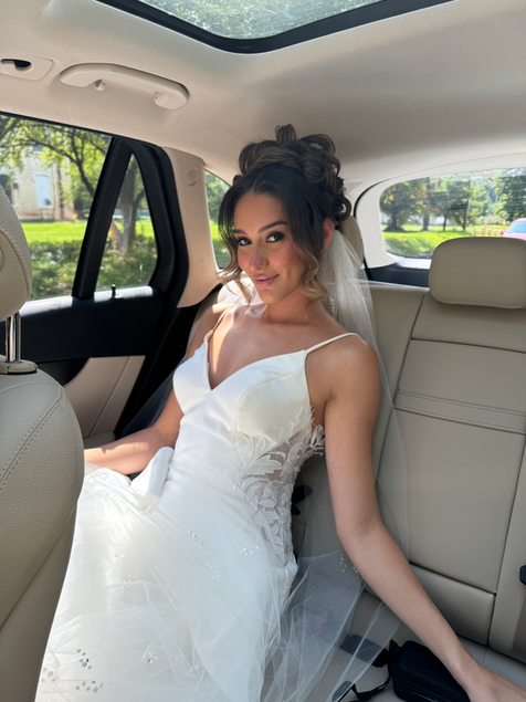 Bride in her wedding dress seated in a limousine, exuding elegance and joy on Long Island