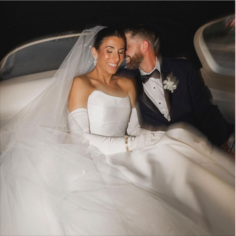 Bride and groom sharing a moment in a limousine, bride showcasing flawless bridal makeup on Long Island