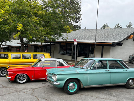 Classic cars in front of a building.