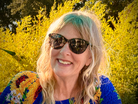 Author, blonde, sunglasses, yellow foliage.