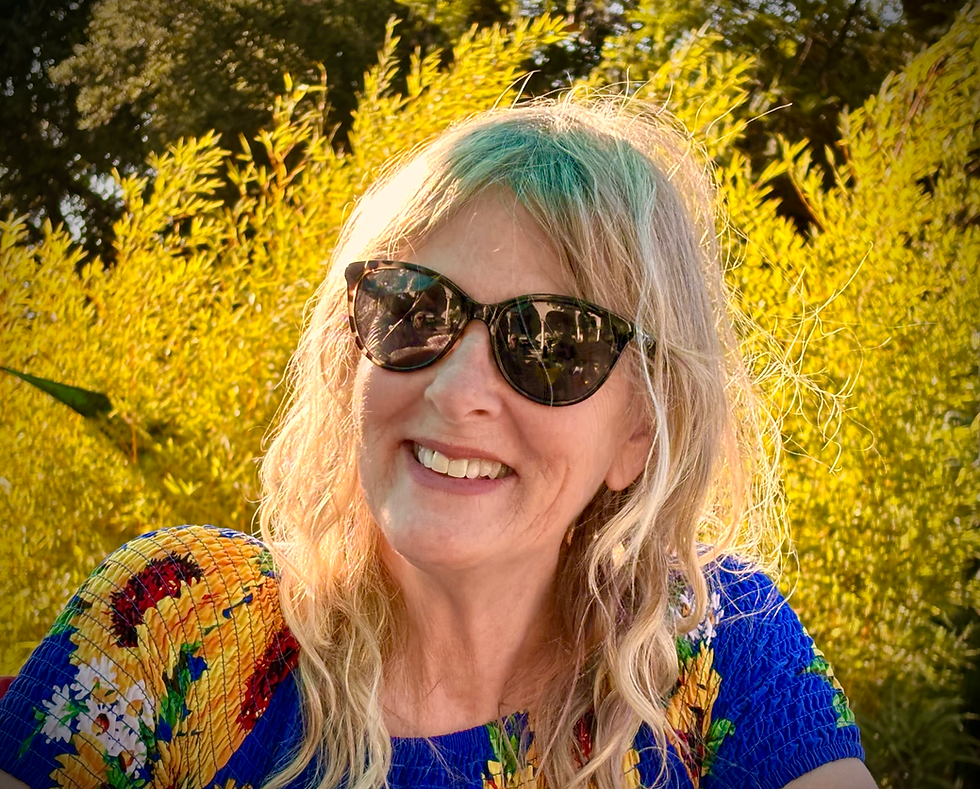 Author, blonde, sunglasses, yellow foliage.