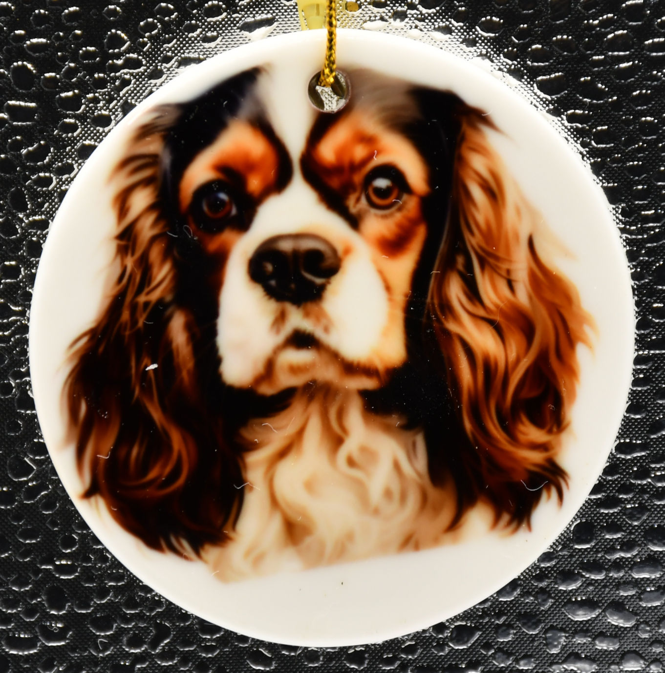portrait of a cavalier king charles spaniel on a white ceramic ornament
