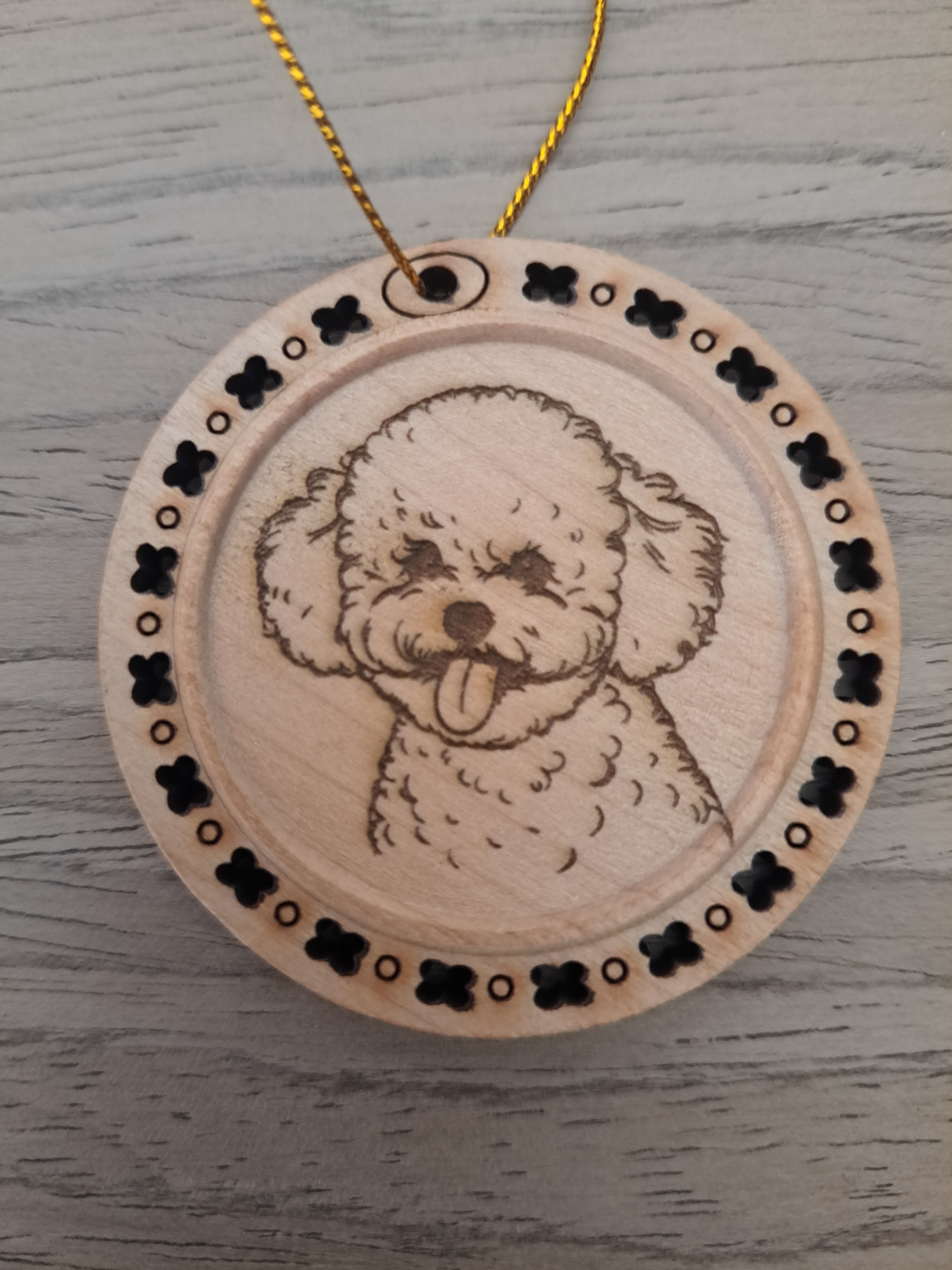 Etched Bichon Frise Dog portrait surrounded by bones on a wood ornament