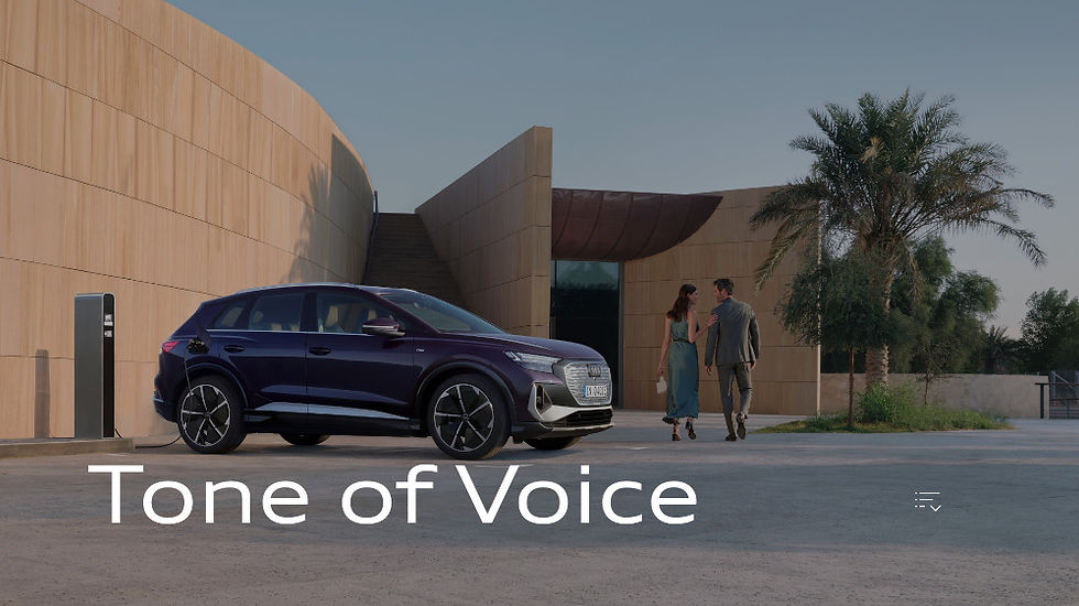 A picture of an Audi 4x4 positioned next to a modern building. A man and woman walk away from the car. Overlaid on the image are the words 'tone of voice'