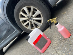 Car tire and detailing spray bottles on the ground My Local Detailer