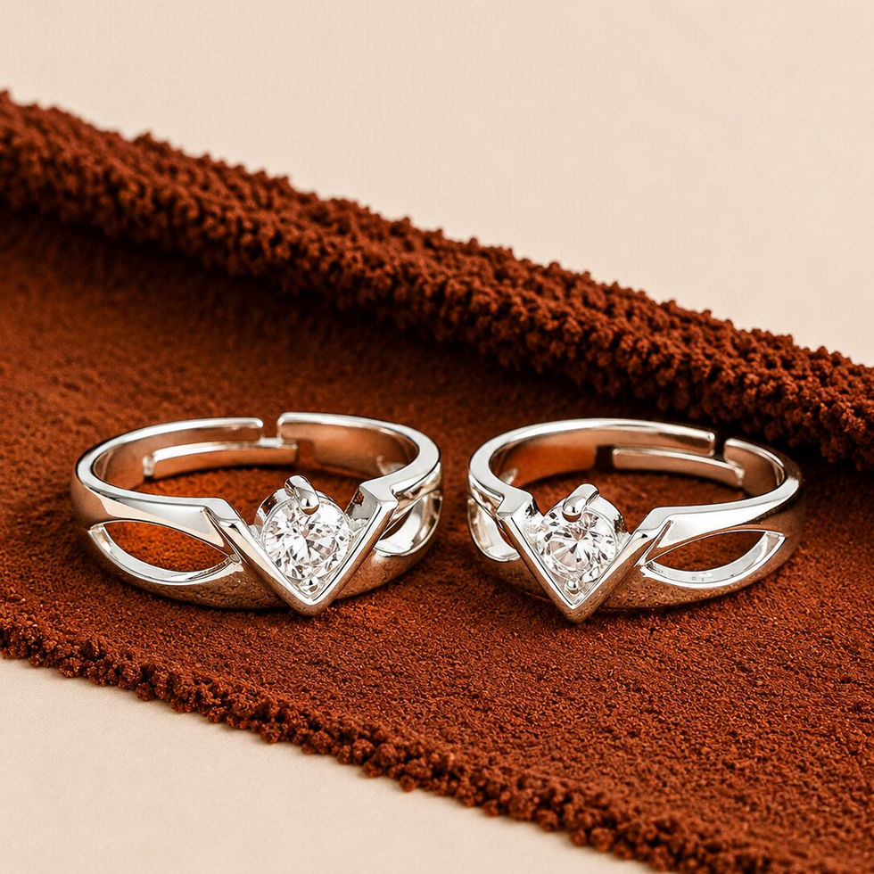 Stylish silver couple rings with V-shaped solitaire design and modern open-cut detailing.